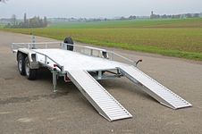 The load area, weight distribution and lashing points of the tandem trailer are specially designed. So the ZÜRN 130-SE fi ts on perfectly. The ramps can be stowed in the frame during  transportation.